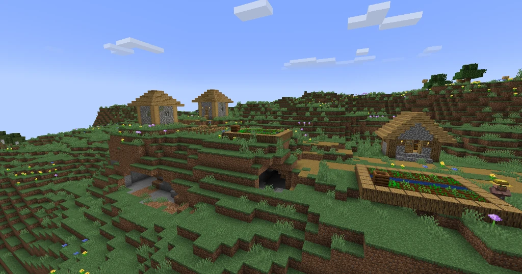 An exposed monster room dungeon entrance carved underneath a Minecraft plains village crop farm on a mountain ridge