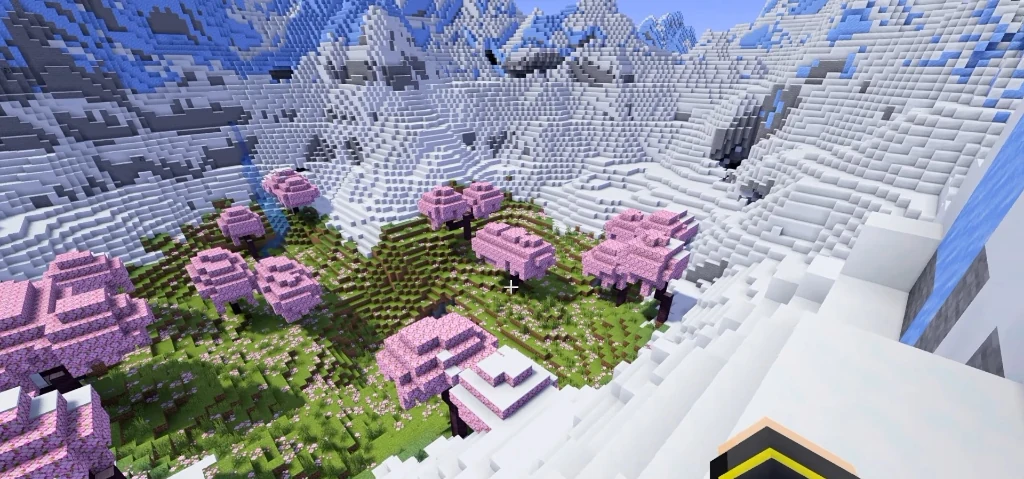 Looking down into the snowy mountain crater enclosing the cherry blossom meadow