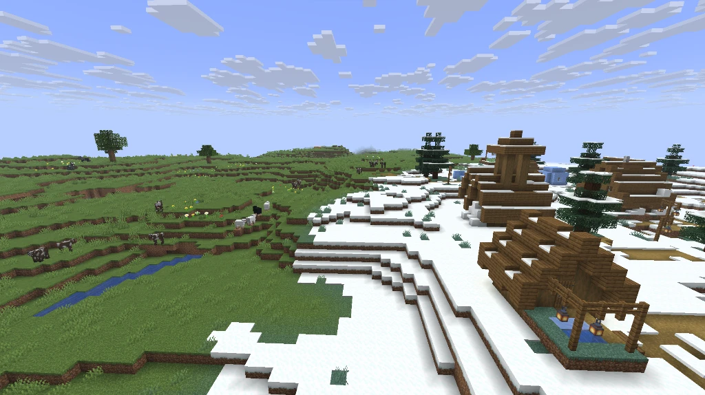 The immediate frontier where the snowy tundra transitions into lush green meadow pastures